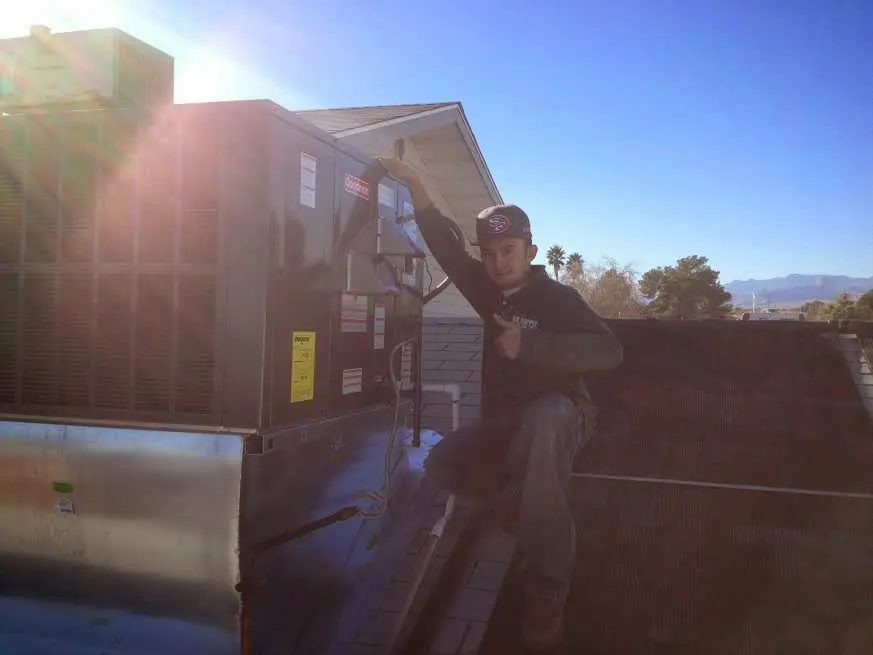HVAC technician performing HVAC Inspection on a rooftop unit in Morrisville